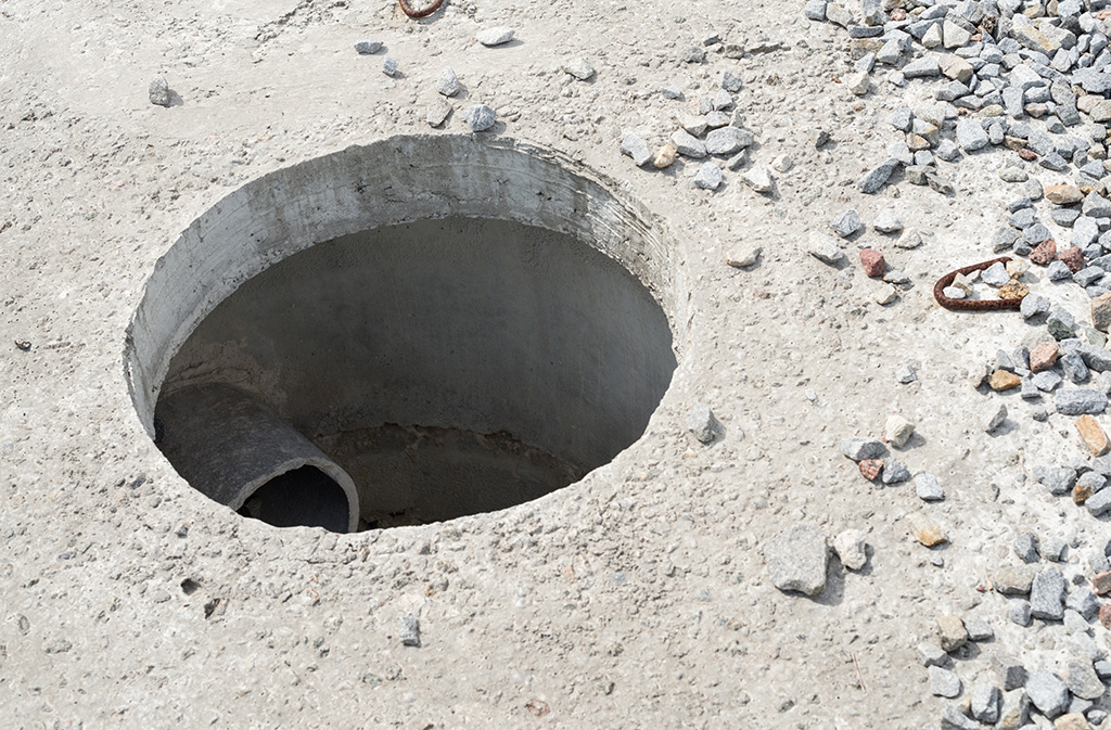 Manhole without cover in new concrete block